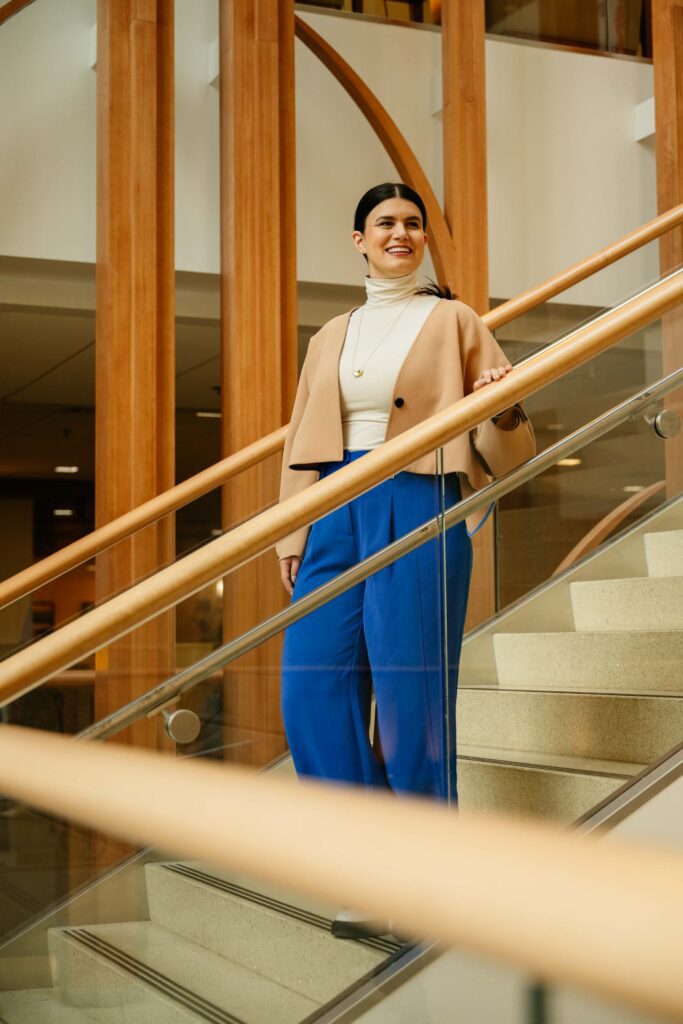 Philanthropist Rebecca Feinglos walks down the steps of the Duke Cancer Center.