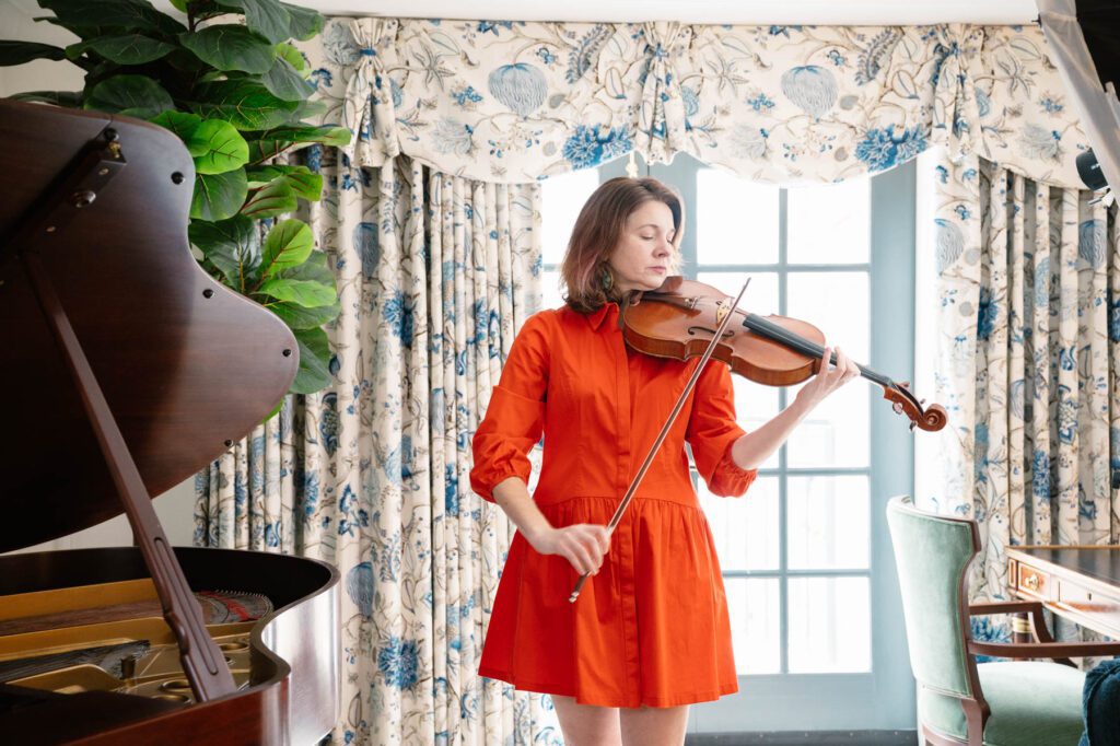 Katie Wyatt plays her viola at the Washington Duke Inn & Golf Club's President's Suite