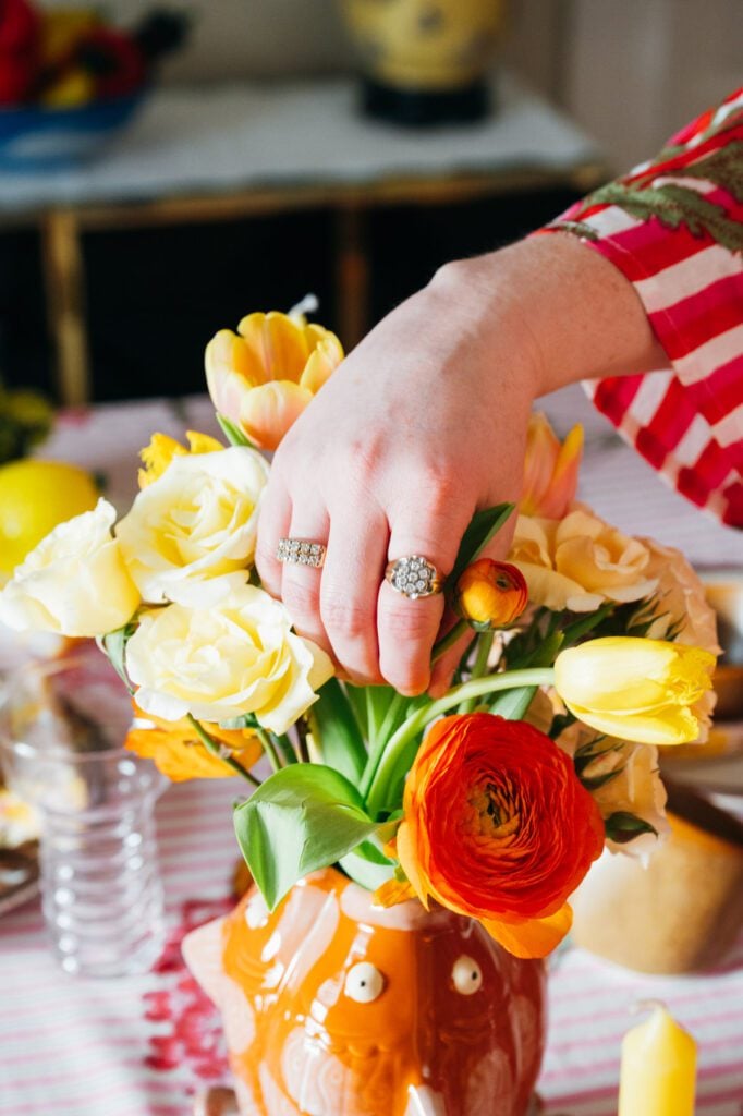 Colorful flower arrangement in a Triplet Koi Vase from The Borough on Courtney Hayes’ dining table.