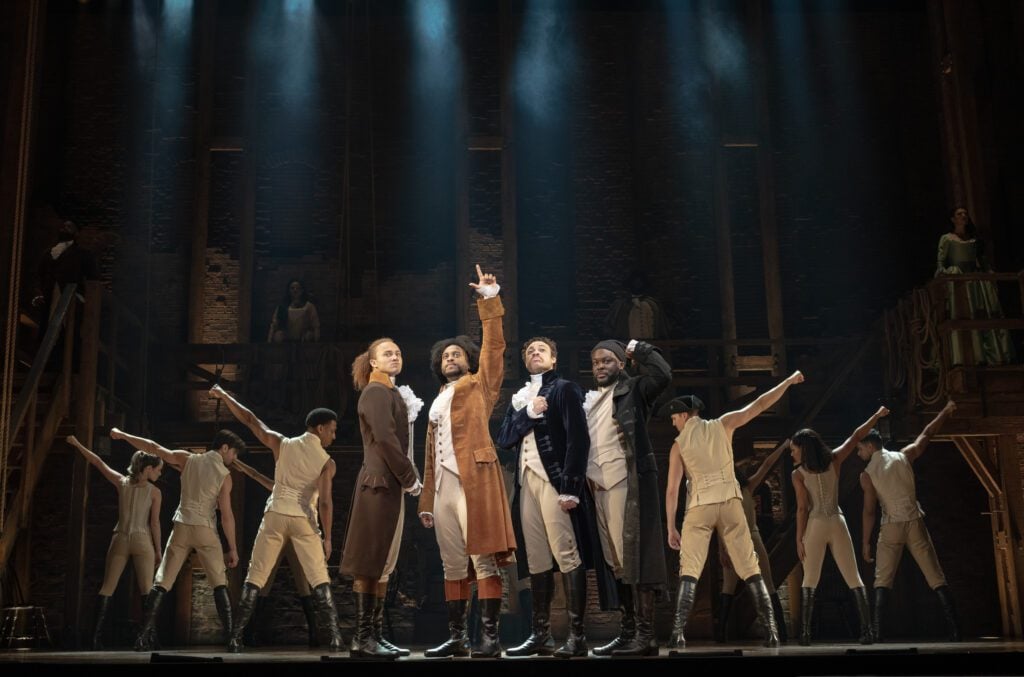 The touring cast of Hamilton onstage.