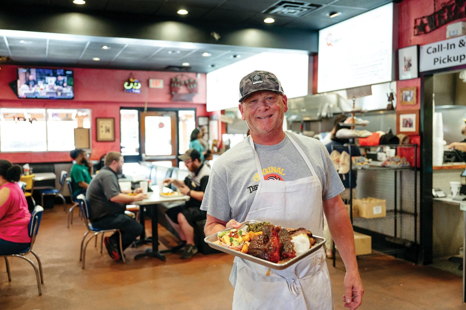 Dan Ferguson of The Original Q Shack with a tray of their barbecue.