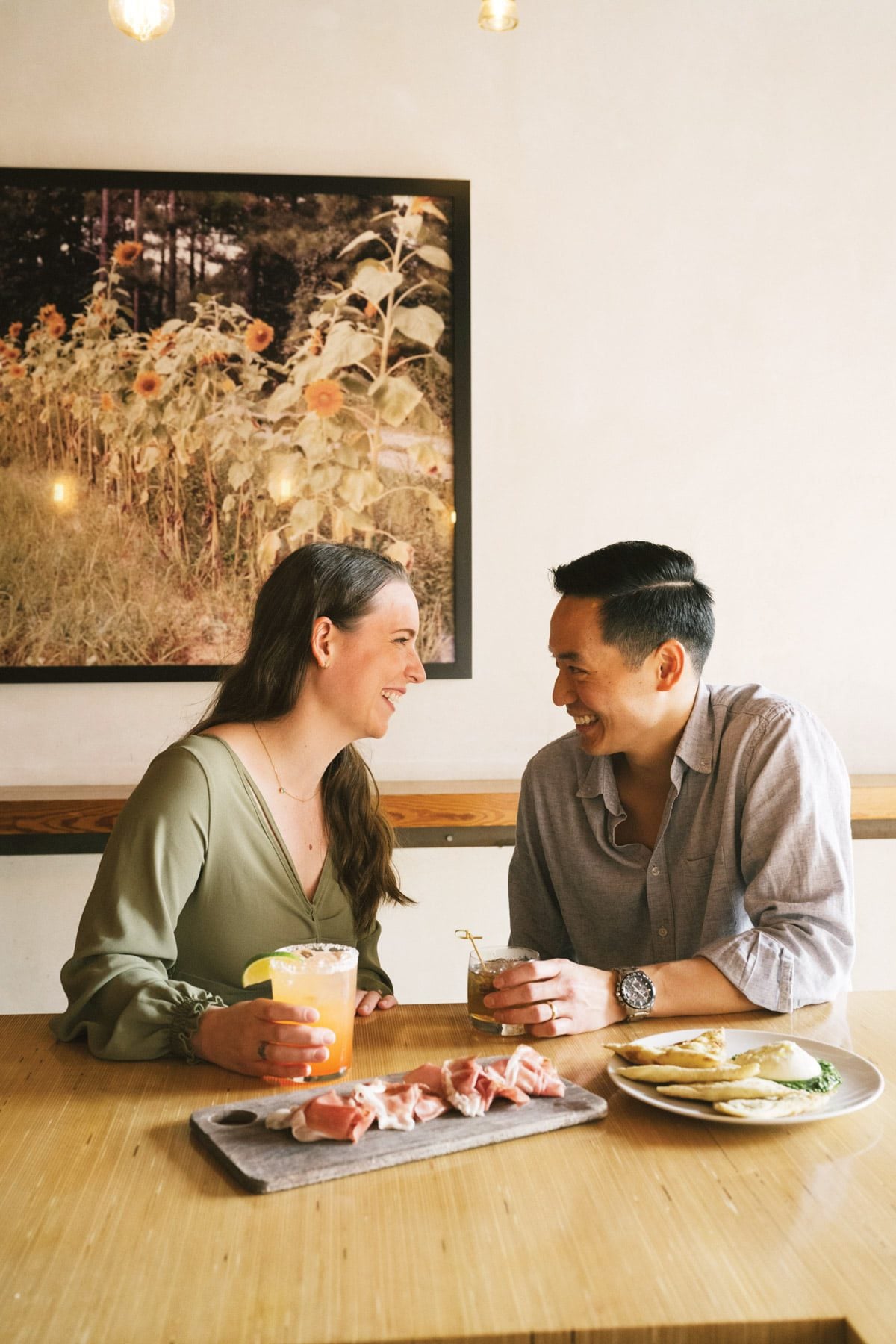 Rachel Lyu and Peter Liu enjoy a drink and laugh together at Pizzeria Toro.
