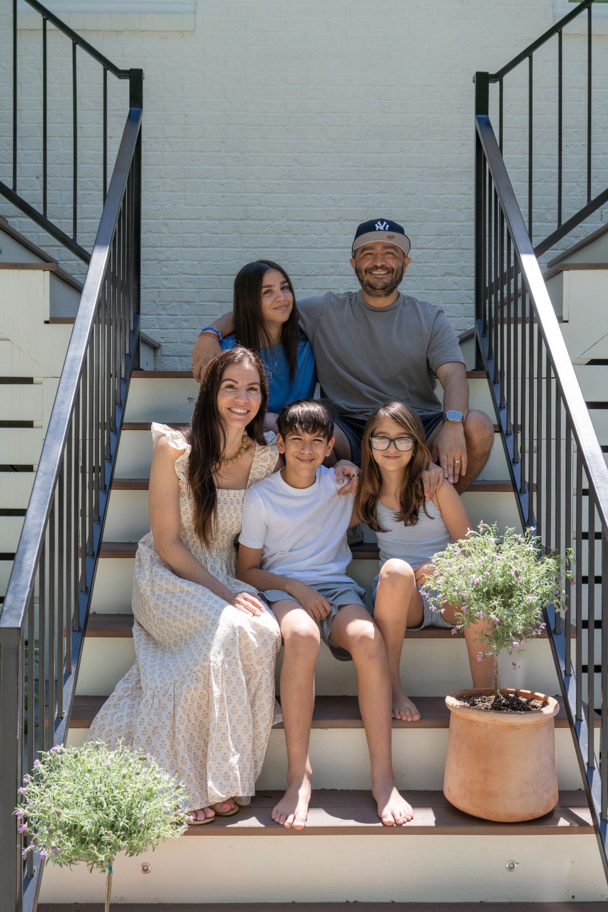 The Serrano family sits on their new staircase.
