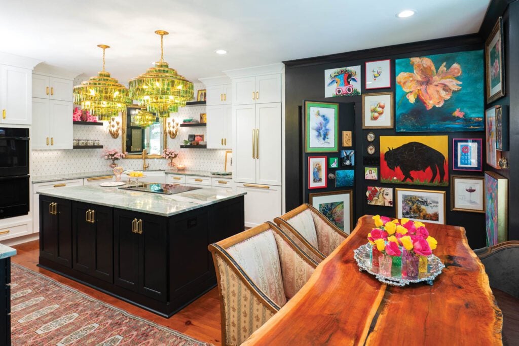 The kitchen and dining room is colorful and eclectic with a hidden door in a wall of paintings that leads to a laundry room crafted by Allie's husband, Mark, in wood.