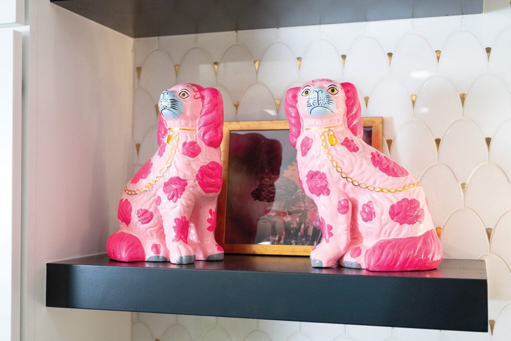 A playful pair of pink ceramic pups live on an open shelve, displaying Allie's love for joyful and personable interior design.