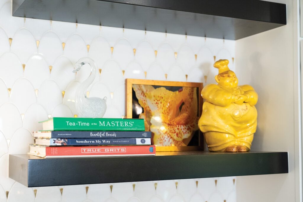 Picture demonstrates Allie Balling's open shelving and colorful aesthetic with a framed abstract photograph that adds a personal touch.