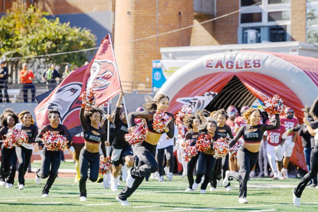 NCCU cheerleaders run onto the O'Kelly-Riddick Stadium field before the start of the homecoming game.
